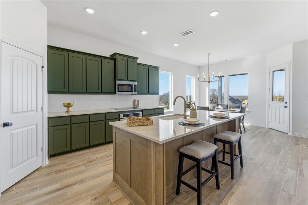 404 Hayden Faith Court Springtown, TX 76082 - Photo 12 of 24 a kitchen with a sink cabinets and wooden floor