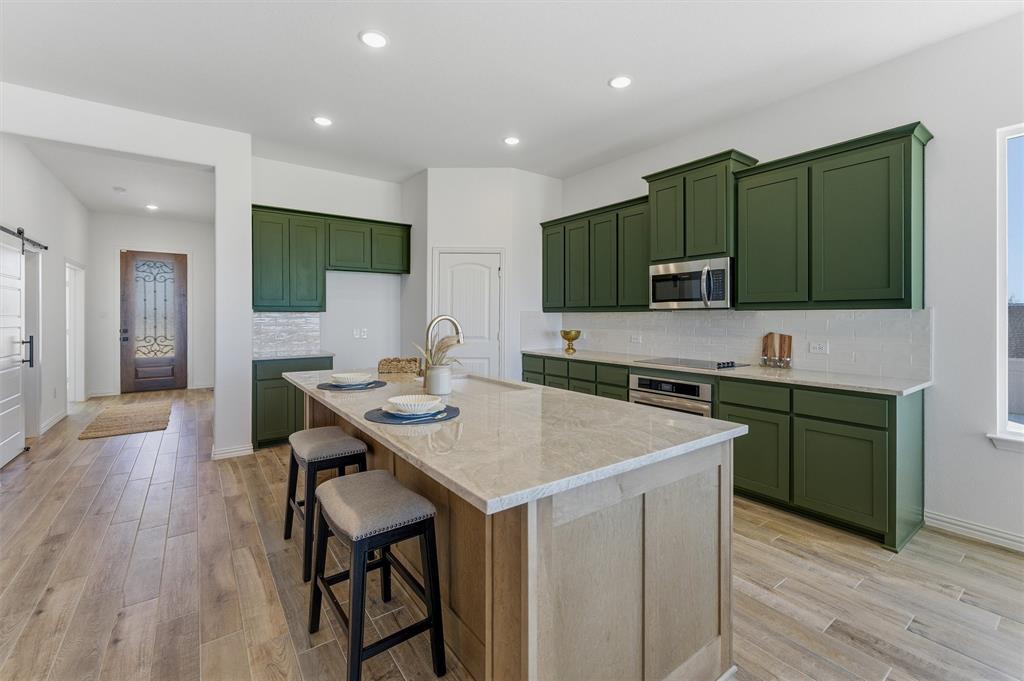 404 Hayden Faith Court Springtown, TX 76082 - Photo 14 of 24 a kitchen with a sink cabinets and wooden floor