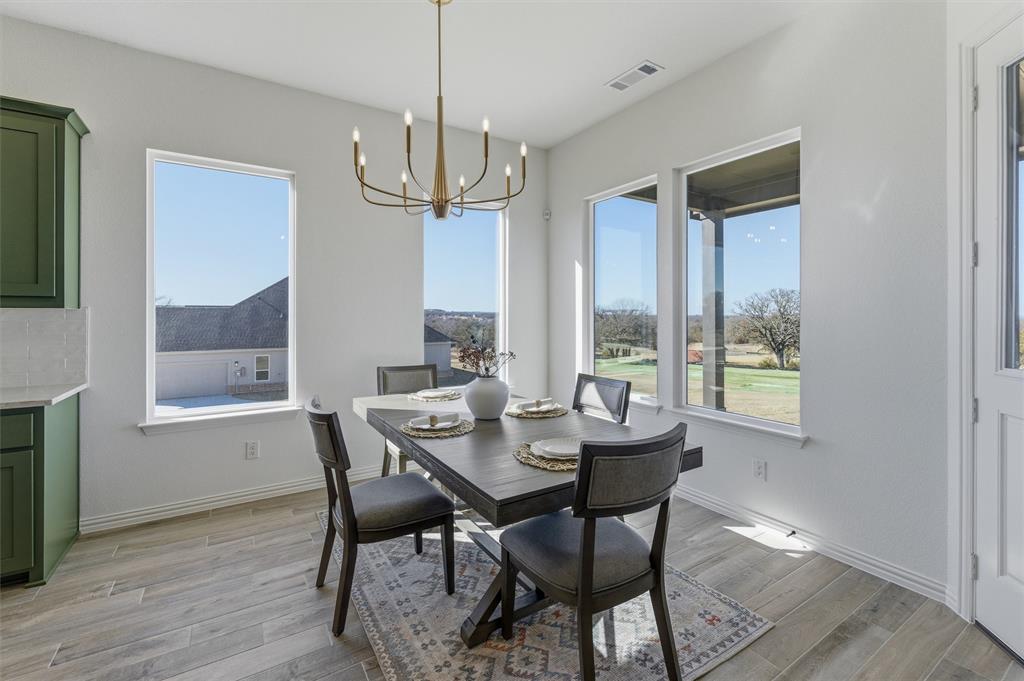 404 Hayden Faith Court Springtown, TX 76082 - Photo 15 of 24 a view of a dining room with furniture window and wooden floor