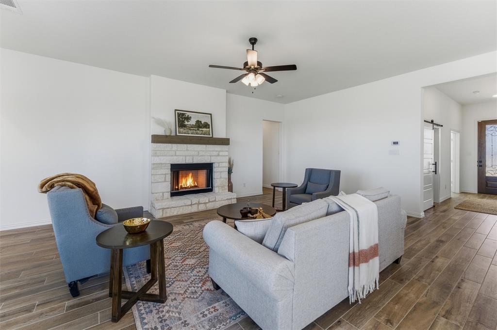 404 Hayden Faith Court Springtown, TX 76082 - Photo 16 of 24 a living room with furniture and a fireplace
