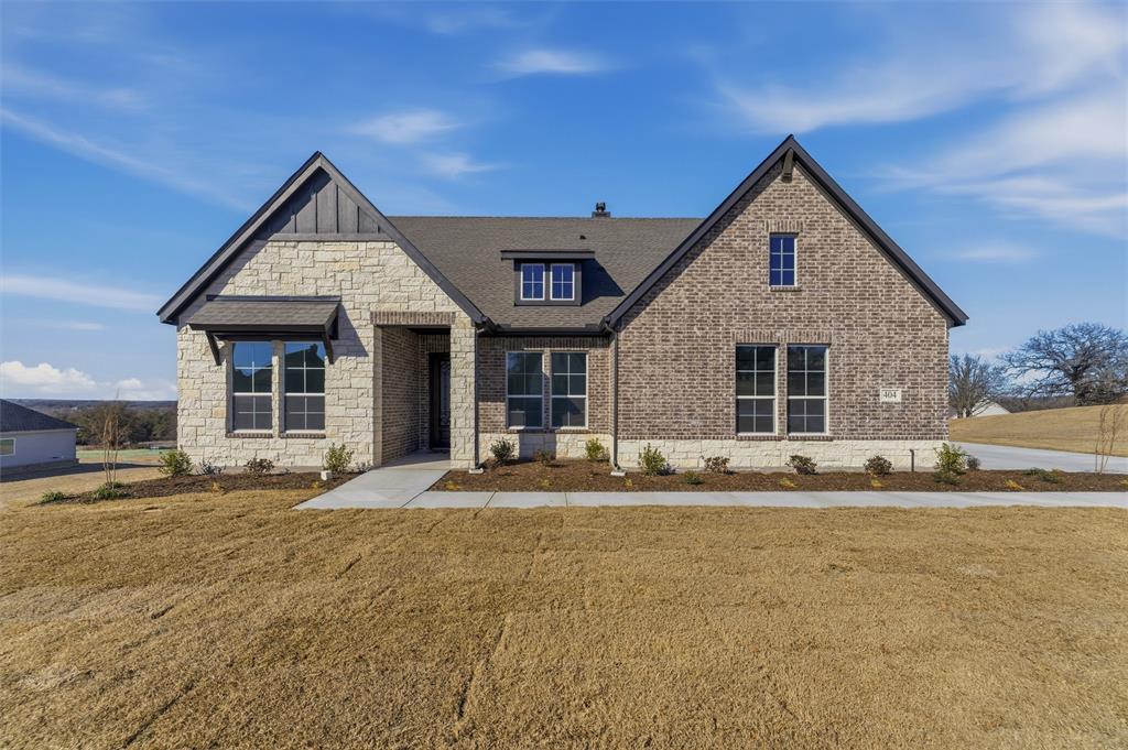 404 Hayden Faith Court Springtown, TX 76082 - Photo 2 of 24 a front view of a house with a outdoor space