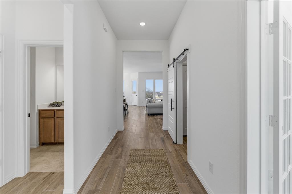 404 Hayden Faith Court Springtown, TX 76082 - Photo 5 of 24 a view of a hallway with a livingroom and a bathroom with sink