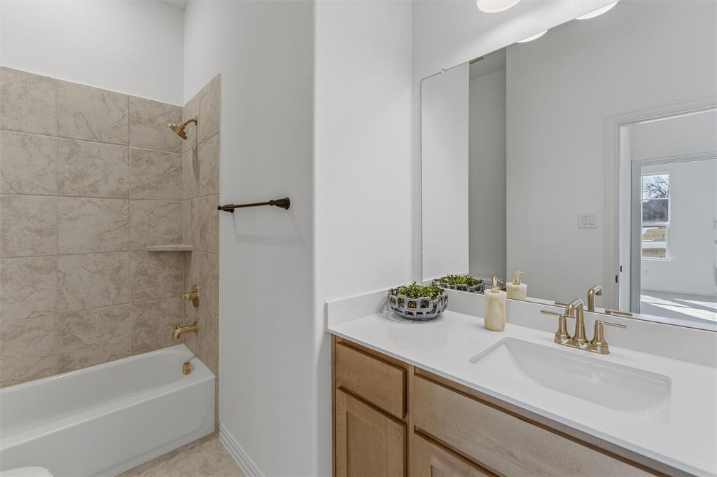404 Hayden Faith Court Springtown, TX 76082 - Photo 8 of 24 a bathroom with a granite countertop sink and a bathtub