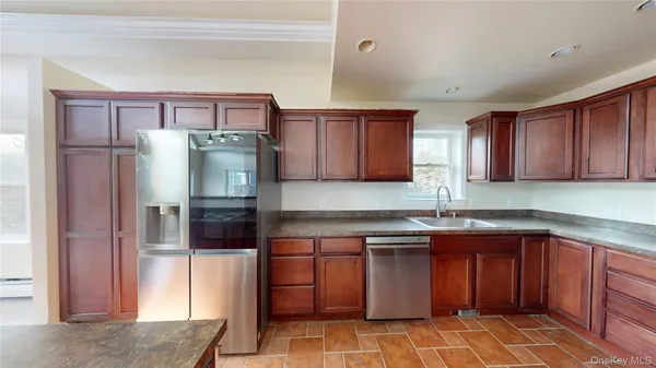 a kitchen with stainless steel appliances granite countertop a refrigerator and a sink