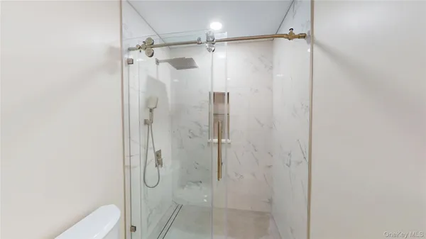 a bathroom with a shower and a glass door
