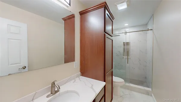 a bathroom with a shower and a sink