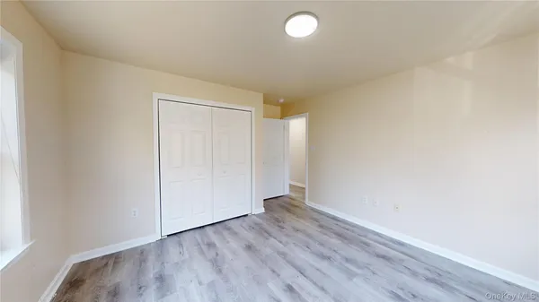 a view of an empty room and wooden floor