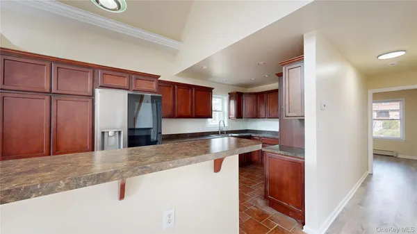 a kitchen with stainless steel appliances granite countertop a refrigerator and a sink