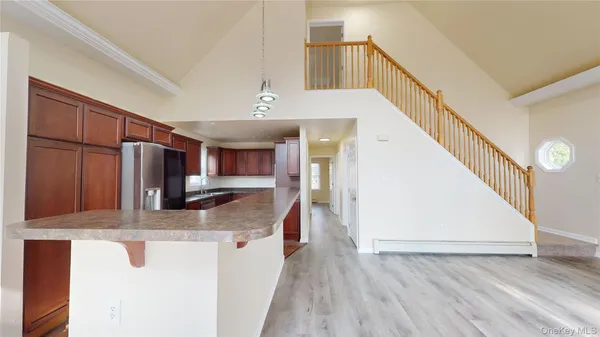 a kitchen with stainless steel appliances granite countertop a sink and a refrigerator