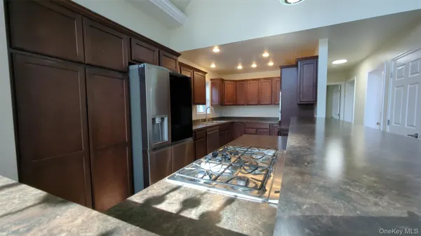 a kitchen with stainless steel appliances granite countertop a refrigerator and a sink