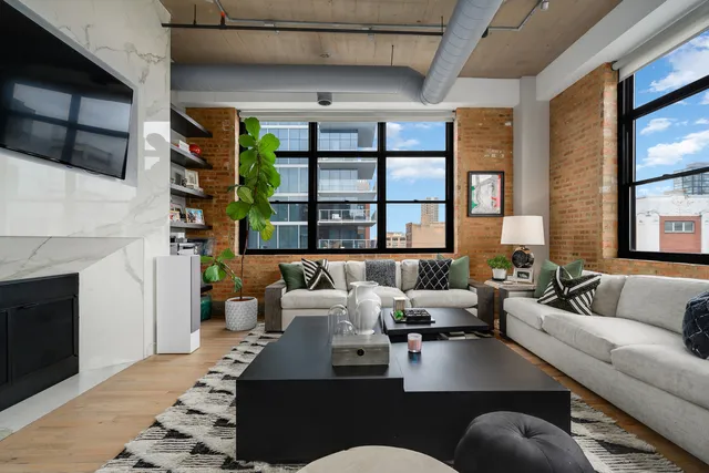a living room with furniture and a fireplace