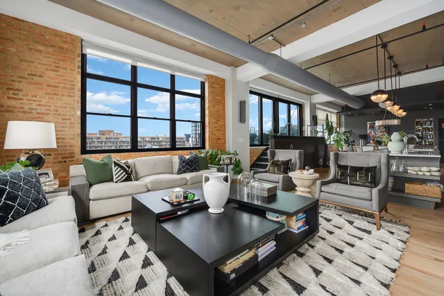a living room with furniture a chandelier and a table