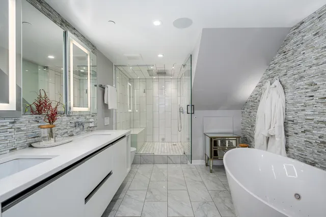 a bathroom with a bathtub sink and a mirror