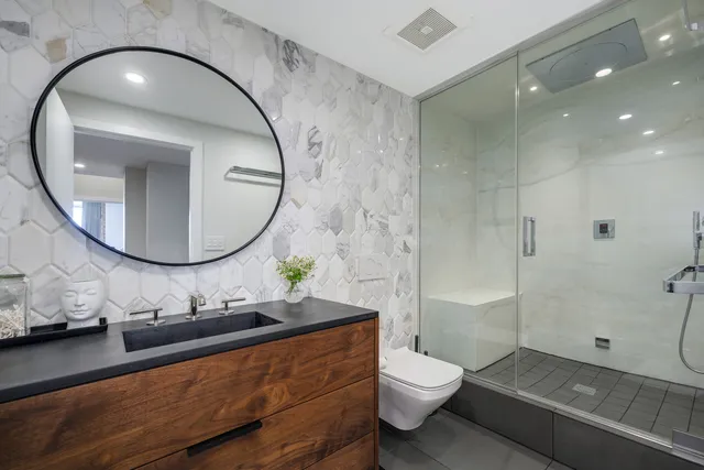 a bathroom with a toilet a sink and a mirror