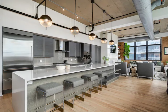 a large kitchen with a table and chairs