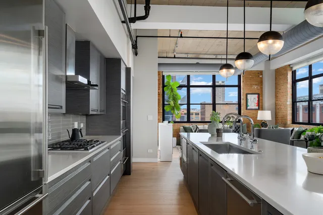 a large kitchen with a large counter top appliances and cabinets