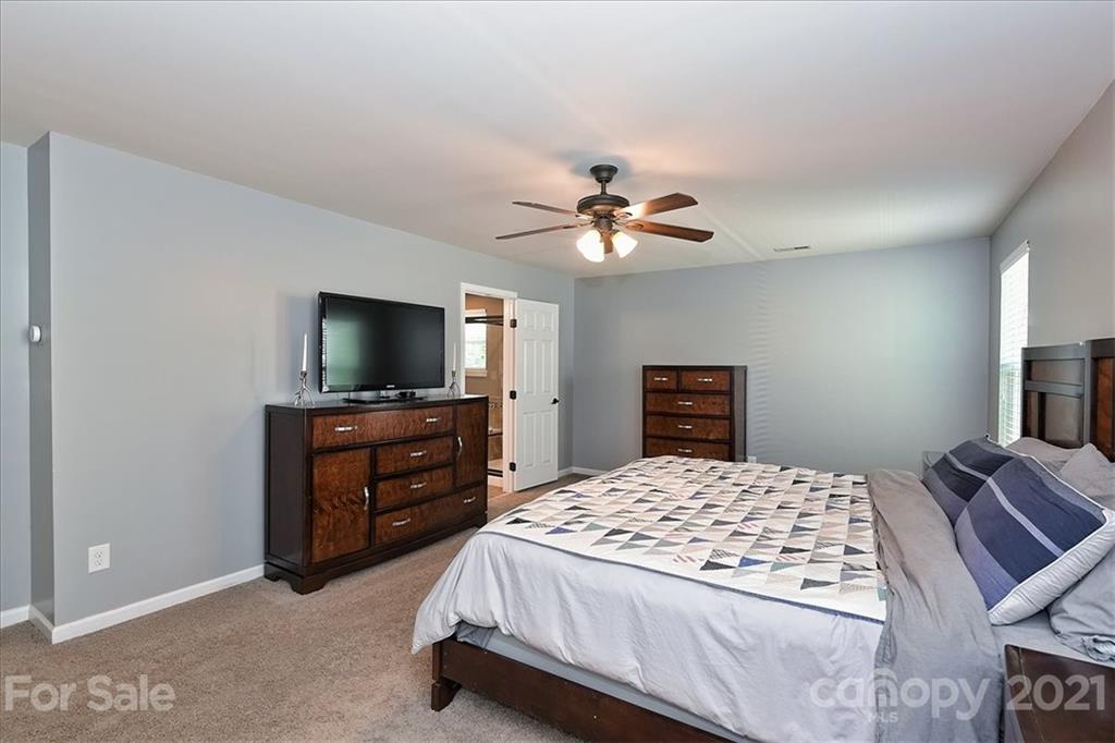 3007 Fallondale Road Waxhaw, NC 28173 - Photo 21 of 46 a bedroom with a bed and a flat screen tv