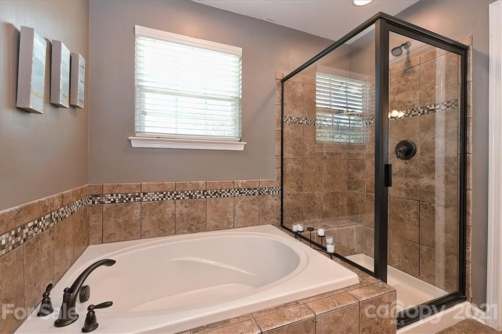 3007 Fallondale Road Waxhaw, NC 28173 - Photo 24 of 46 a bathroom with a bathtub and shower