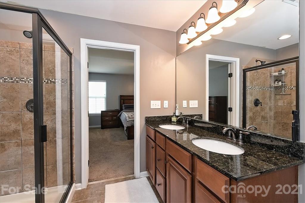 3007 Fallondale Road Waxhaw, NC 28173 - Photo 25 of 46 a en suite bathroom with a granite countertop sink and a mirror