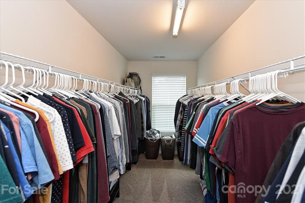 3007 Fallondale Road Waxhaw, NC 28173 - Photo 26 of 46 a view of walk in closet with clothes and shoes