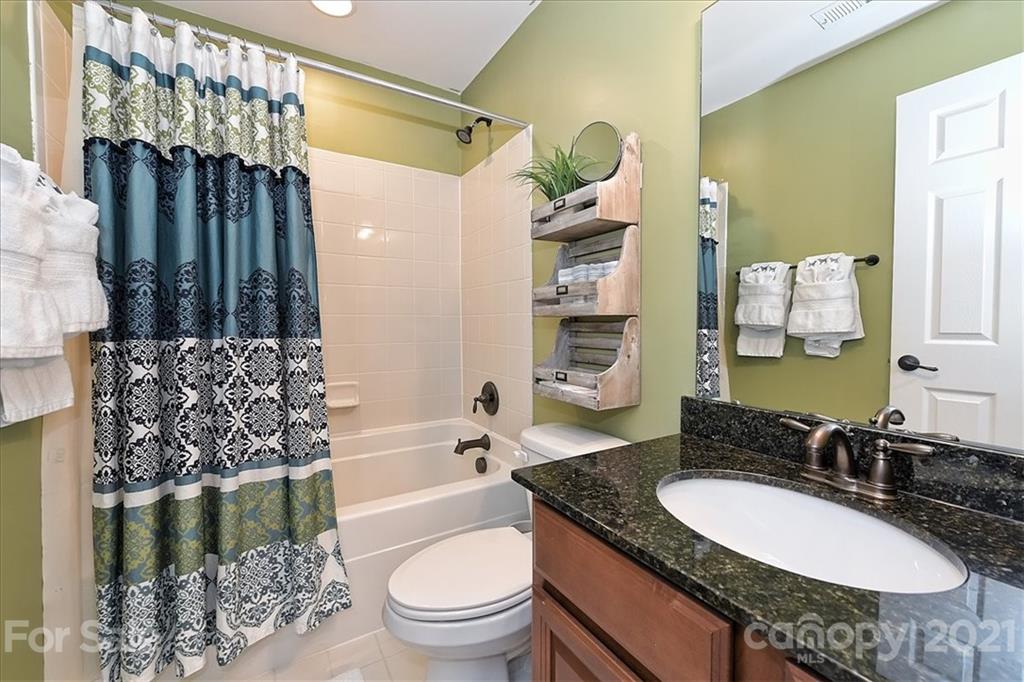 3007 Fallondale Road Waxhaw, NC 28173 - Photo 30 of 46 a bathroom with a granite countertop toilet sink and mirror