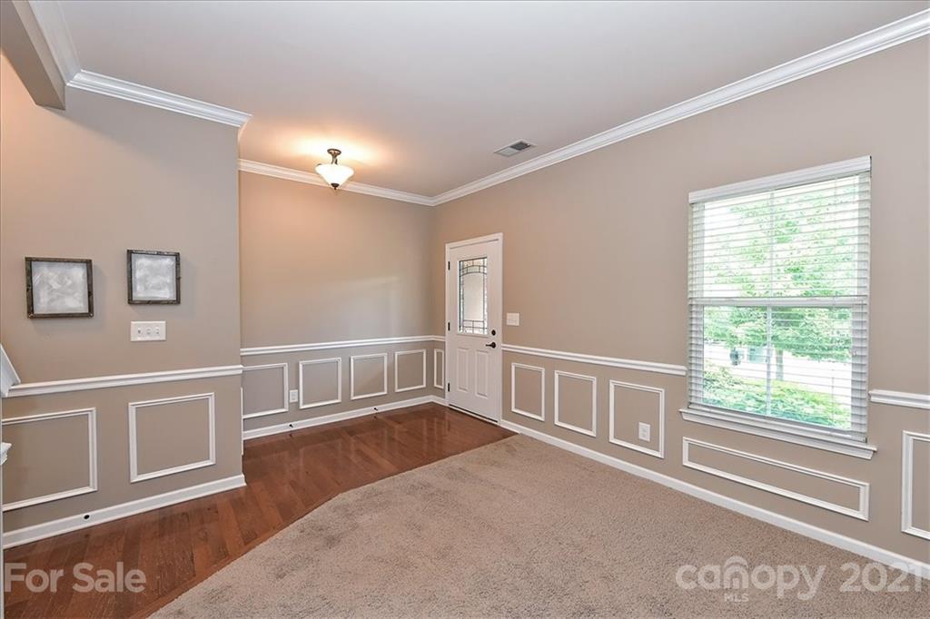 3007 Fallondale Road Waxhaw, NC 28173 - Photo 4 of 46 a view of an empty room with wooden floor and a window