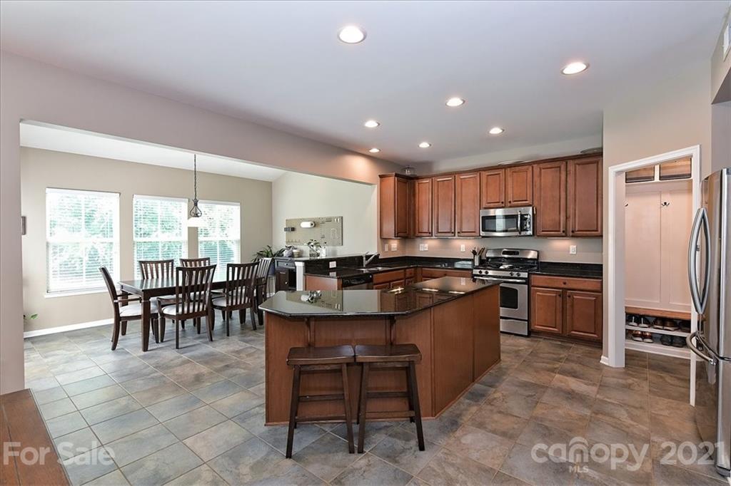 3007 Fallondale Road Waxhaw, NC 28173 - Photo 10 of 46 a large kitchen with kitchen island a dining table and chairs