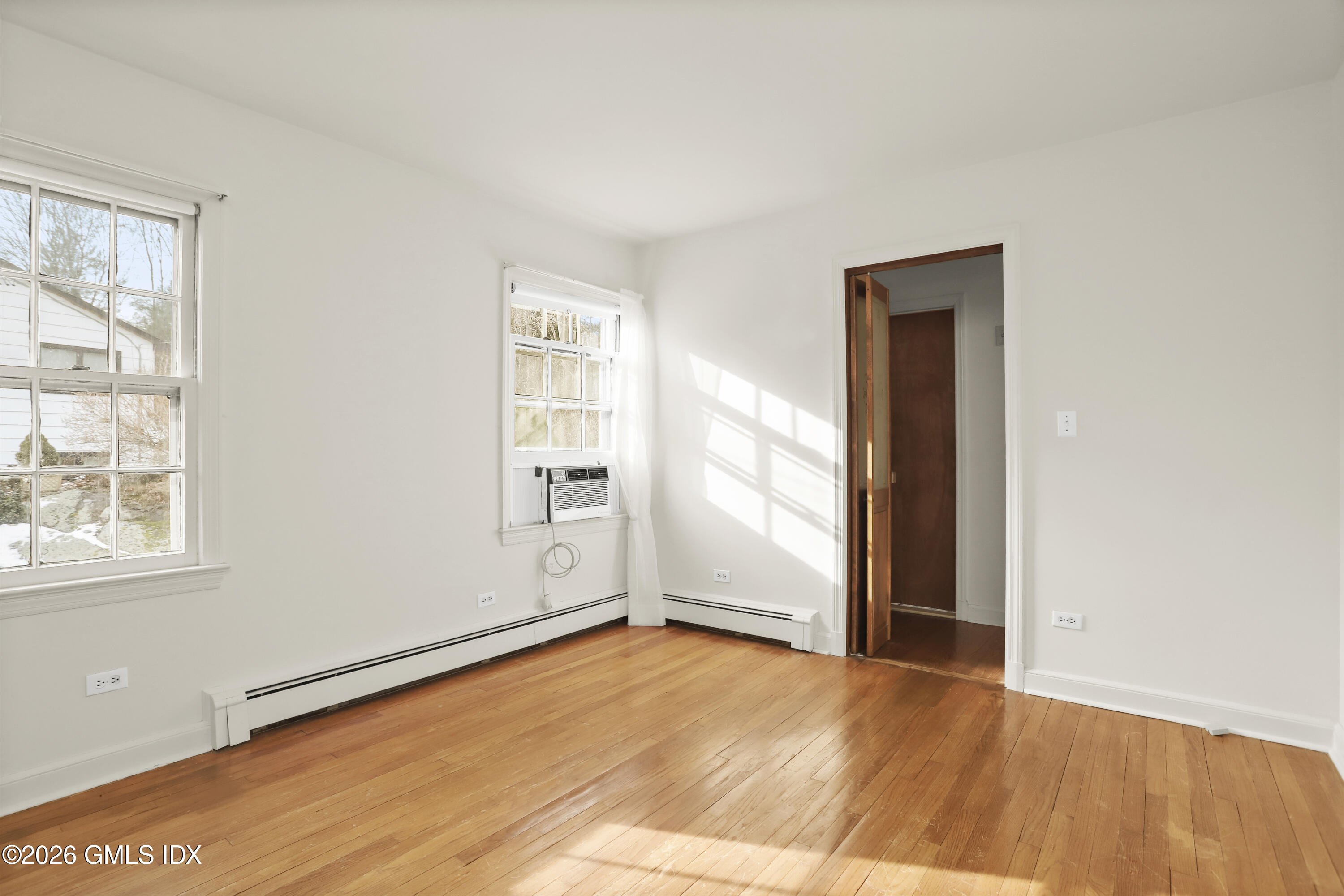 200 Weaver Street, Unit B Greenwich, CT 06831 - Photo 16 of 30 an empty room with wooden floor and windows