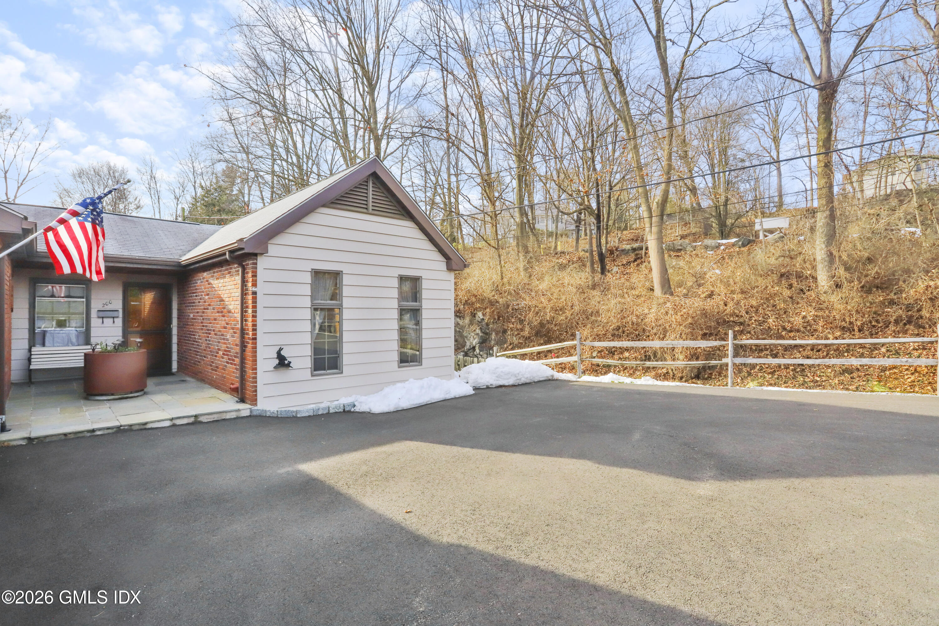 200 Weaver Street, Unit B Greenwich, CT 06831 - Photo 27 of 30 a view of a house with a yard and garage