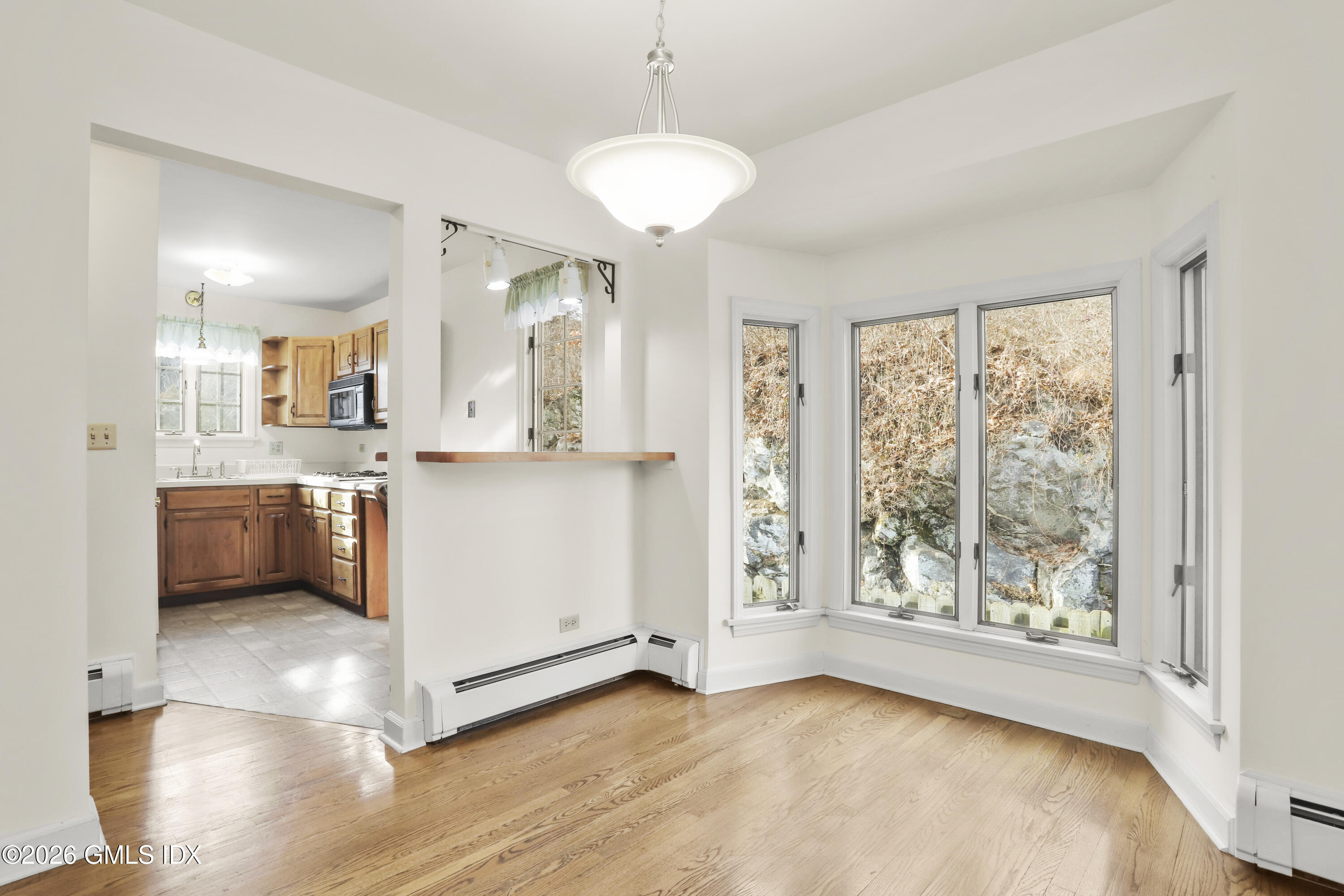 200 Weaver Street, Unit B Greenwich, CT 06831 - Photo 6 of 30 a view of a kitchen with a sink dishwasher and a microwave