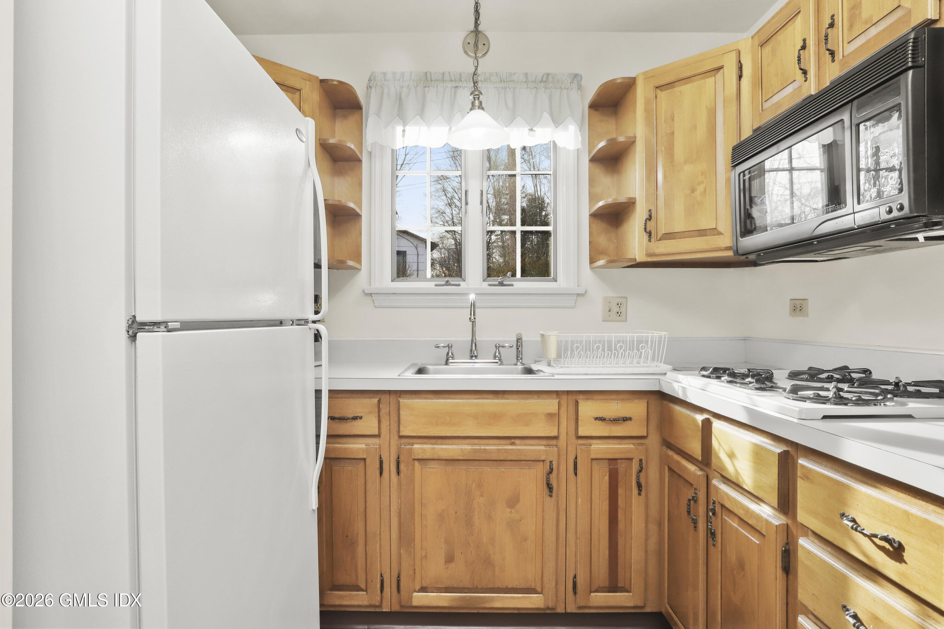 200 Weaver Street, Unit B Greenwich, CT 06831 - Photo 7 of 30 a kitchen with a sink and cabinets