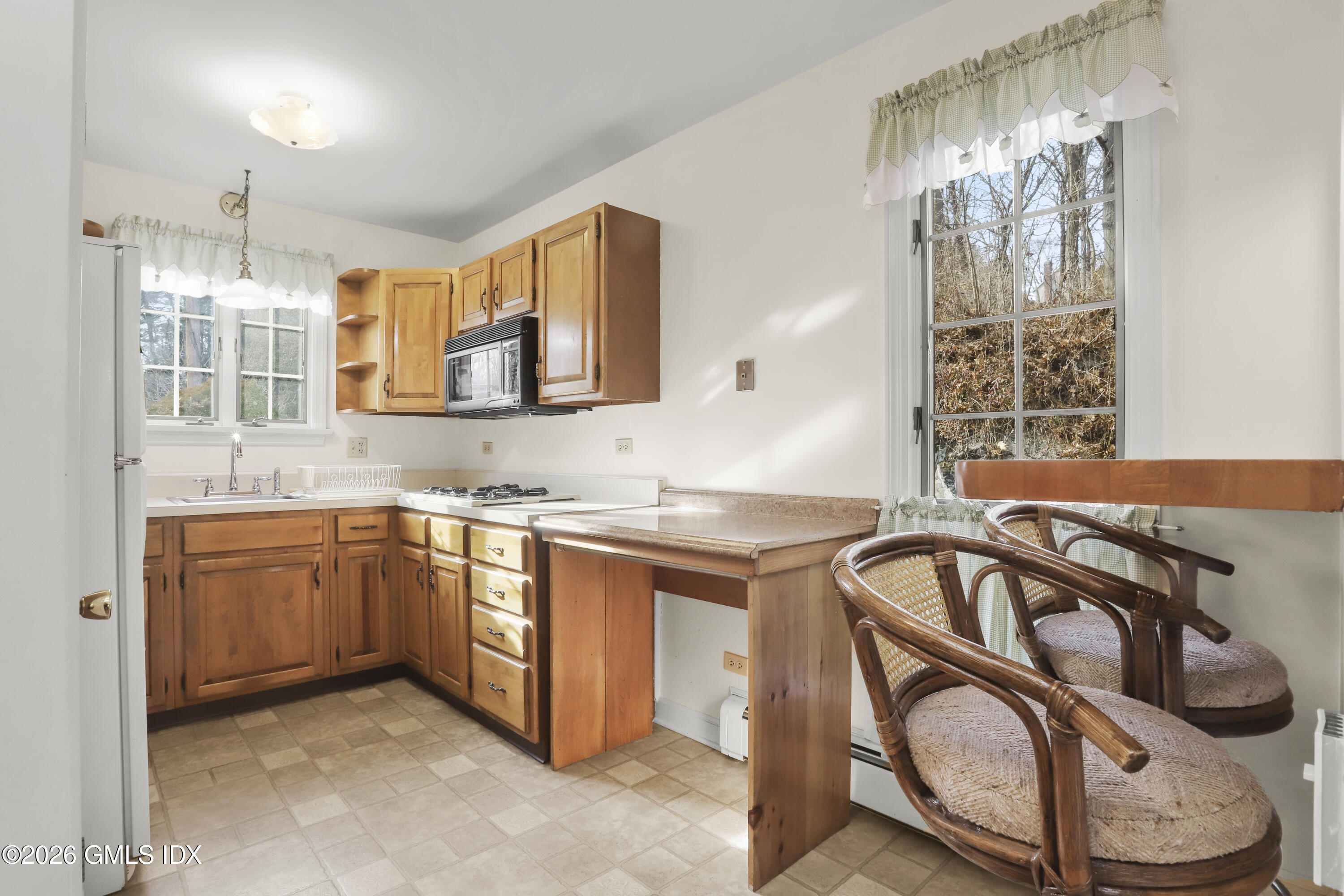 200 Weaver Street, Unit B Greenwich, CT 06831 - Photo 8 of 30 a kitchen with stainless steel appliances granite countertop a sink a stove and a wooden floors