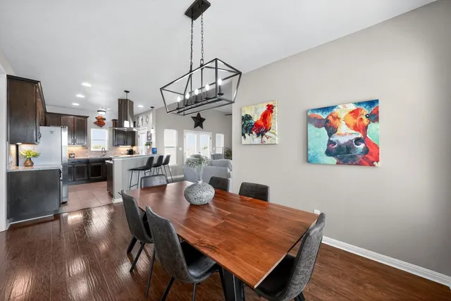 a view of a dining room with furniture wooden floor and a chandelier