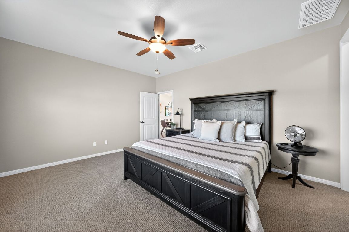 813 Cr 342 Road Granger, TX 76530 - Photo 13 of 32 a bedroom with a bed and a chandelier