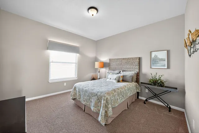 a bedroom with a bed and window