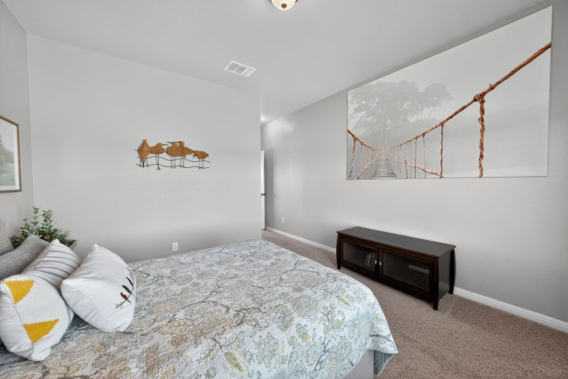 813 Cr 342 Road Granger, TX 76530 - Photo 17 of 32 a bedroom with a bed and painting on the wall