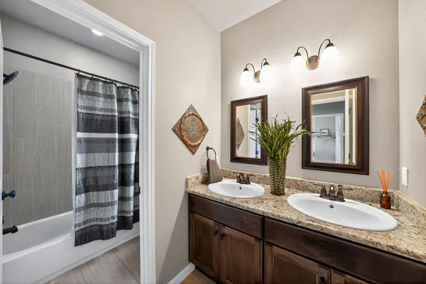 a bathroom with a double vanity sink and a mirror