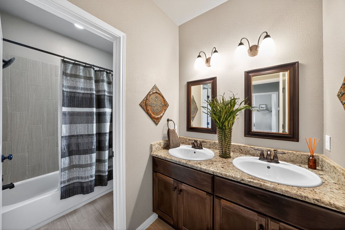 813 Cr 342 Road Granger, TX 76530 - Photo 18 of 32 a bathroom with a double vanity sink and a mirror