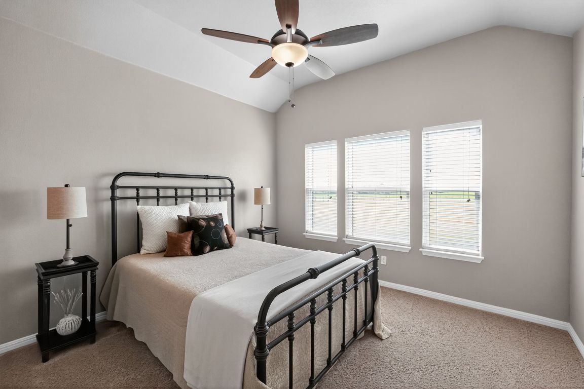 813 Cr 342 Road Granger, TX 76530 - Photo 19 of 32 a bedroom with a bed and a chandelier