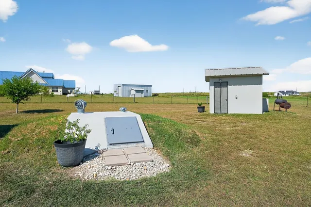 a view of a house with a yard and a garden