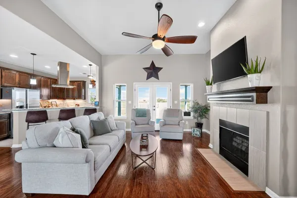 a living room with furniture a fireplace and a flat screen tv