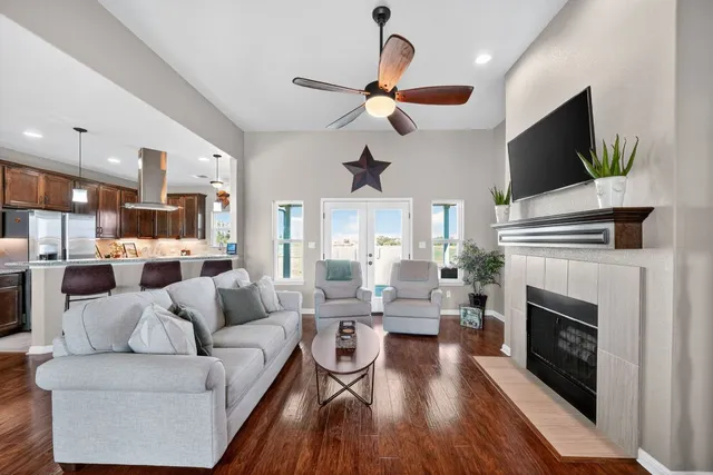 a living room with furniture a fireplace and a flat screen tv
