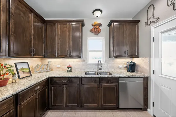 a kitchen with a sink and cabinets