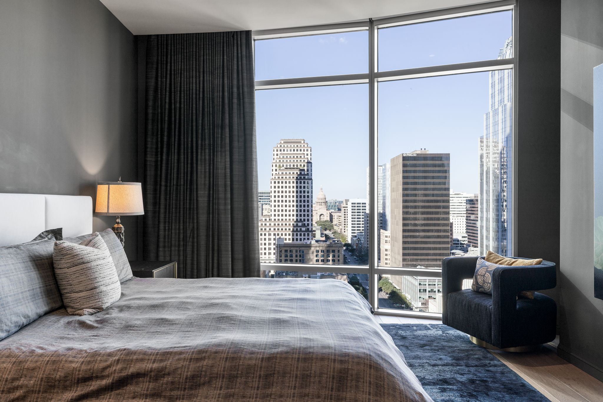 200 Congress Avenue, Unit 21D Austin, TX 78701 - Photo 18 of 34 Primary bedroom with city views and a custom made blackout curtiain