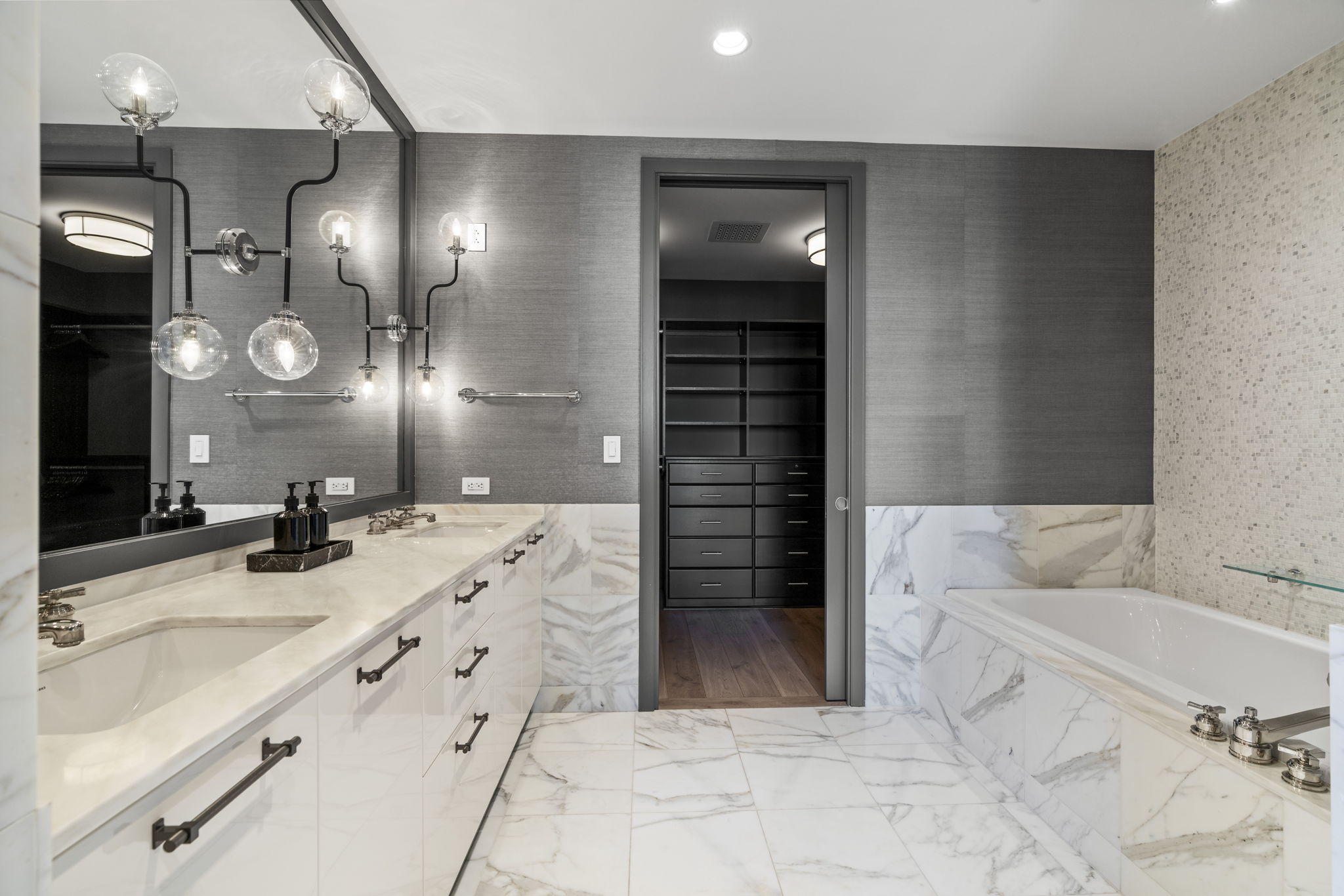 200 Congress Avenue, Unit 21D Austin, TX 78701 - Photo 20 of 34 Bathroom with a spacious closet, double vanity, a bath, light marble finish flooring, and soaking tub