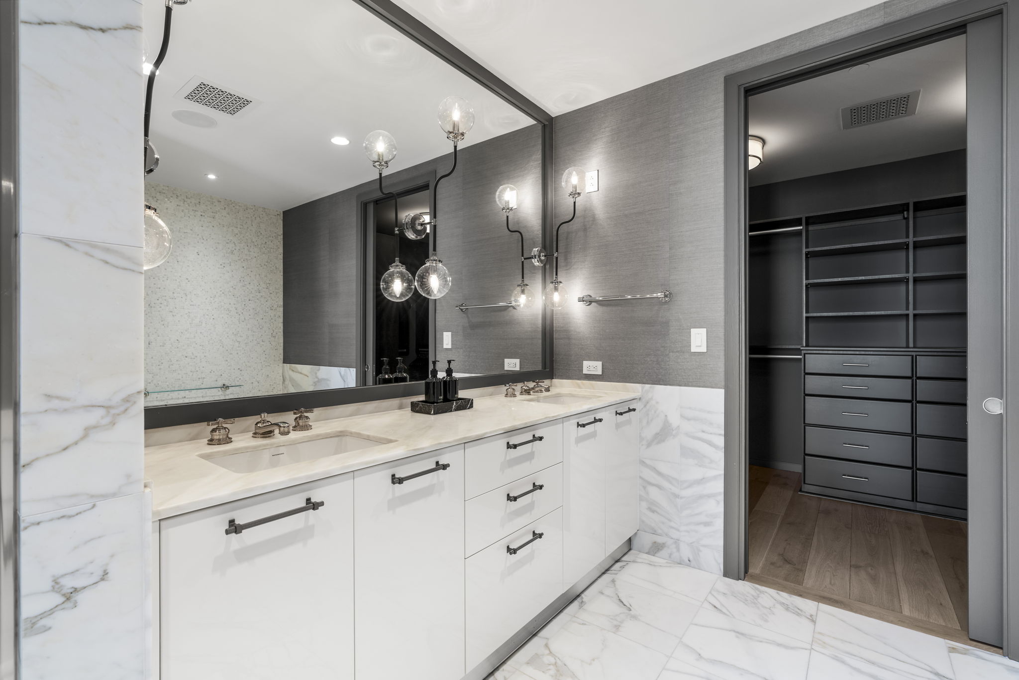200 Congress Avenue, Unit 21D Austin, TX 78701 - Photo 21 of 34 En suite primary bath featuring light marble finish floors, double vanity, and a walk in closet