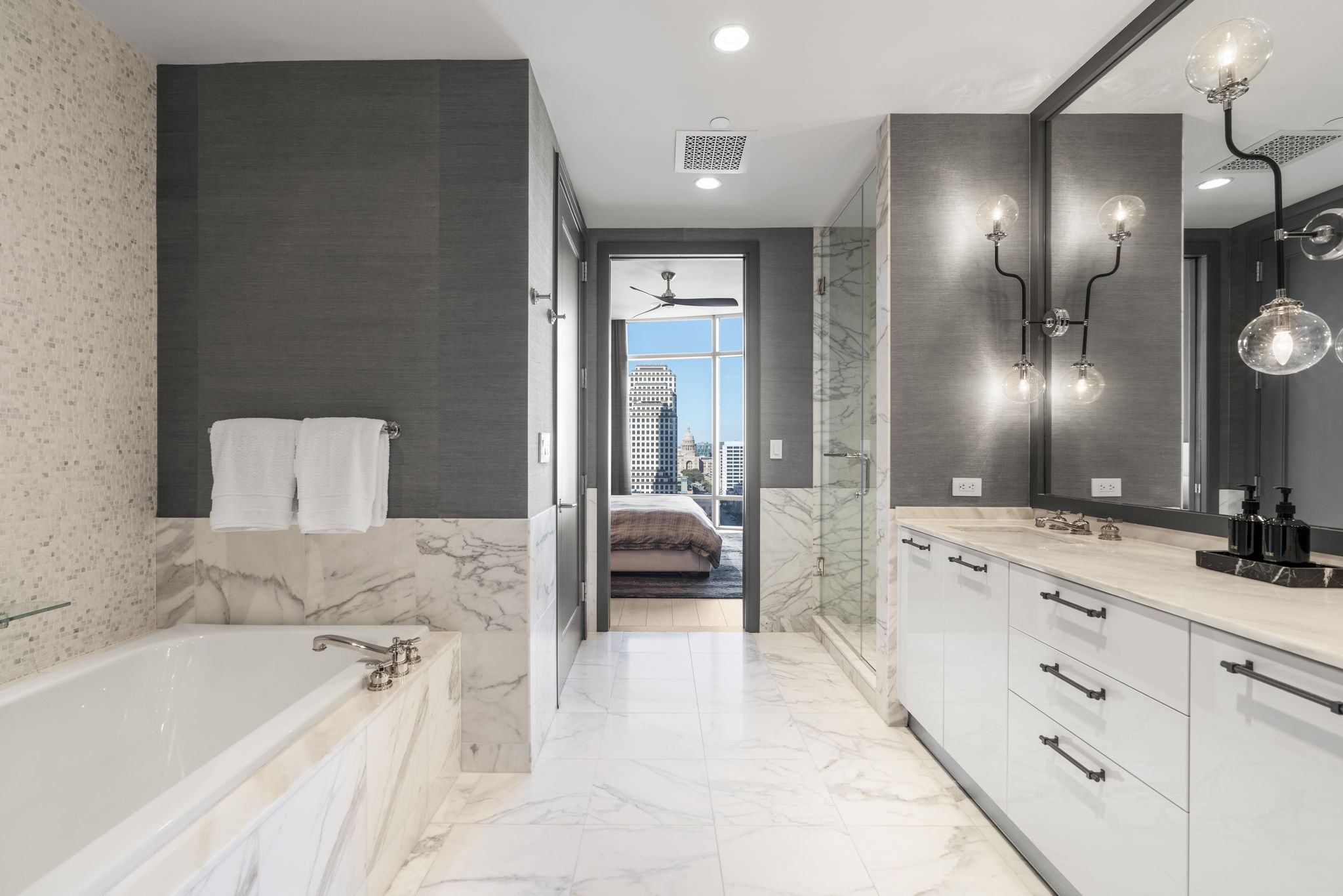 200 Congress Avenue, Unit 21D Austin, TX 78701 - Photo 23 of 34 Ensuite bathroom featuring double vanity, a bath, recessed lighting, light marble finish floors, and a marble finish shower