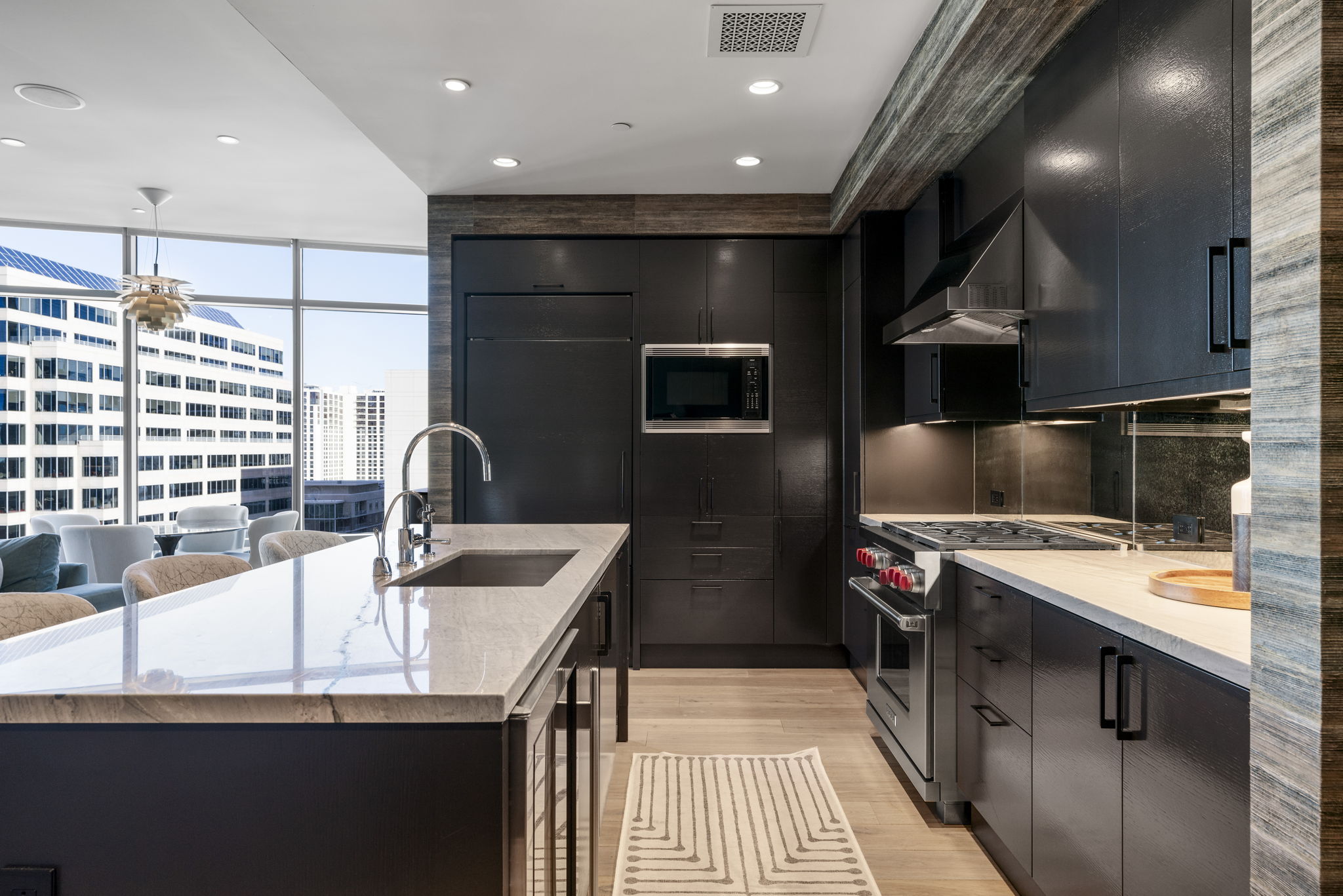 200 Congress Avenue, Unit 21D Austin, TX 78701 - Photo 10 of 34 Kitchen with built in appliances, modern cabinets, and light stone counters