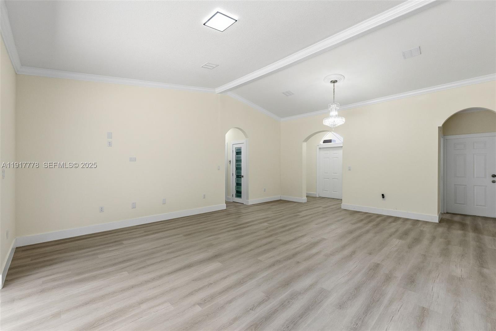 19601 Southwest 128th Court Miami, FL 33177 - Photo 11 of 59 an empty room with wooden floor and windows