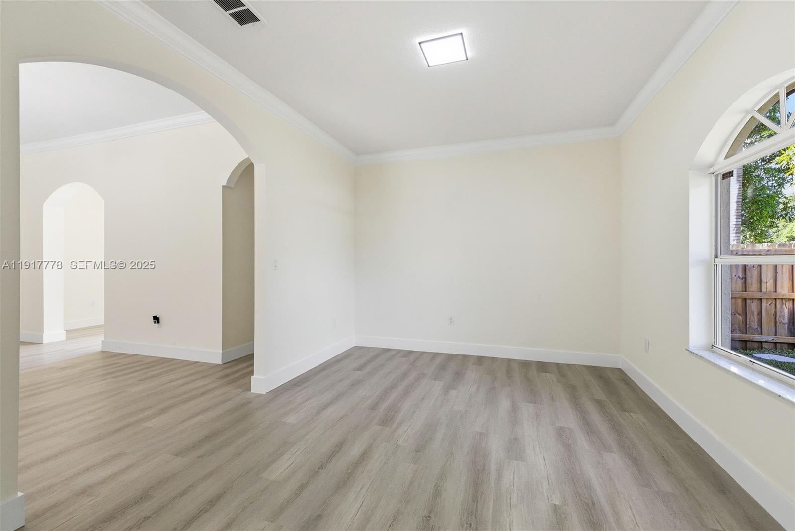 19601 Southwest 128th Court Miami, FL 33177 - Photo 14 of 59 an empty room with wooden floor and windows